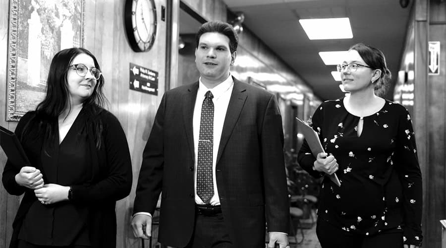 Real estate team walking in a hallway after a closing.